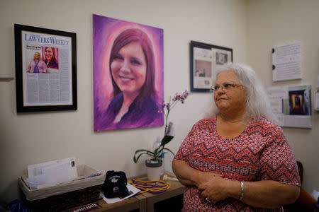 Susan Bro, mother of Heather Heyer, who was killed during the August 2018 white nationalist rally in Charlottesville, looks at mementos of her daughter in her office in Charlottesville, Virginia, U.S., July 31, 2018. REUTERS/Brian Snyder