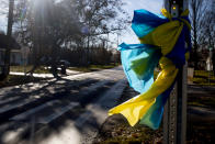 Navy blue and gold ribbons are wrapped around a stop sign one-quarter mile south of Oxford High School on Thursday, Dec. 2, 2021 in Oxford, Mich. A 15-year-old sophomore opened fire at his Michigan high school on Tuesday, killing four students, including a 16-year-old boy who died in a deputy’s patrol car on the way to a hospital, authorities said. (Jake May/The Flint Journal via AP)