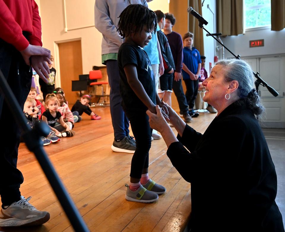 Dance director Jo Ann Warren reassures Noelle Okai, 3, that the music won't always be as loud as she lends a hand with an upcoming performance at the T.E.C. Schools at Trinity Lutheran Church in Worcester.