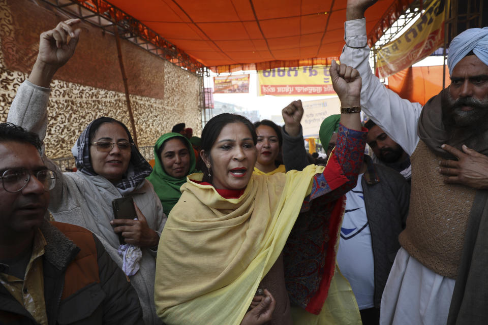Woman farmer Sohajdeep Kaur, 40, center, with others shout slogans as they block a highway in protest against new farm laws at the Delhi-Haryana state border, on the outskirts of New Delhi, India, Sunday, Dec. 27, 2020. From students, teachers and nurses to housewives and grandmothers, women are now holding the front lines at the massive protests that have blockaded key highways leading to India's capital for more than a month, demanding the repeal of new farm laws. (AP Photo/Manish Swarup)