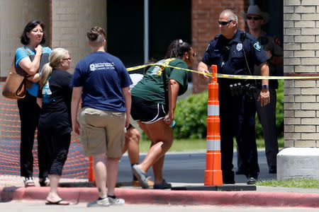 Students are escorted into Santa Fe High School to retrieve their belongings, in Santa Fe, Texas, U.S., May 22, 2018. REUTERS/Jonathan Bachman