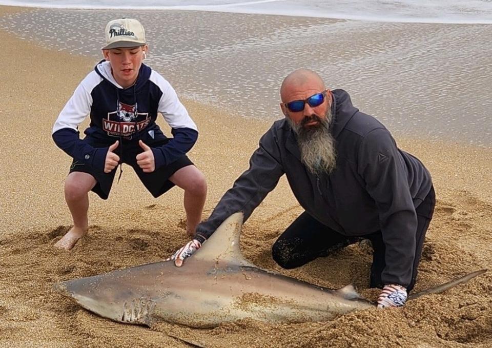 Dustin Smith, the NSB Shark Hunter, appears to have a satisfied customer, Abel from Indiana, who landed a blacktip longer than he is.