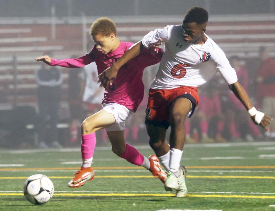 Bridgewater-Raynham's Aiden Cullinane keeps the ball away from Durfee's Lens Boursiquot, during a game on Tuesday, Oct. 25, 2022.  