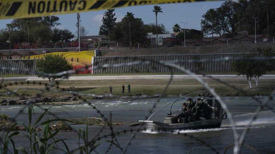 People in Piedras Negras, Mexico, are seen taking photos, through recently installed concertina wire, of the U.S. side as Border Patrol agents patrol Rio Grande in Eagle Pass, Texas on Nov. 8, 2021. (Verónica G. Cárdenas for ProPublica/The Texas Tribune)