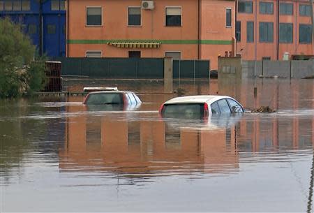 Submerged cars are seen on a flooded street in San Gavino Monreale on Sardina island November 18, 2013. REUTERS/Rosaspress