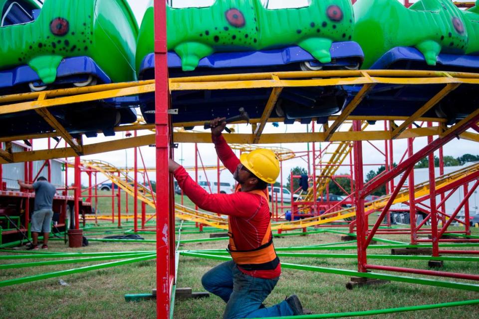 Workers assemble the Wacky Worm ride Tuesday, Oct. 12, 2021 at the NC State Fair in Raleigh. The North Carolina fair opens on Thursday and inspectors with the labor department must insure nearly 100 rides meet safety standards.
