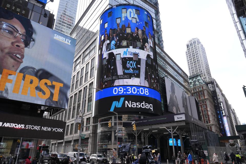 Pedestrians walk past the Nasdaq building Tuesday, March 26, 2024, in New York. Trump Media, which runs the social media platform Truth Social, now takes Digital World's place on the Nasdaq stock exchange. (AP Photo/Frank Franklin II)