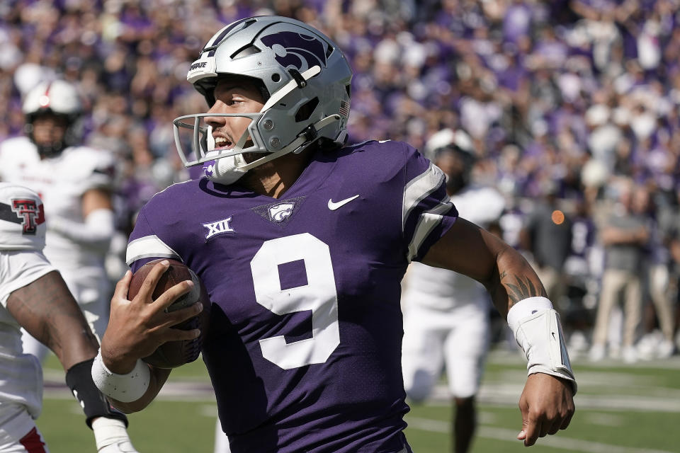 FILE - Kansas State quarterback Adrian Martinez runs the ball during the first half of an NCAA college football game against Texas Tech Saturday, Oct. 1, 2022, in Manhattan, Kan. Kansas State quarterback Adrian Martinez and Iowa linebacker Jack Campbell were among 15 players named finalists Wednesday, Oct. 26, 2022, for the William V. Campbell Trophy, given to college football's top scholar-athlete.(AP Photo/Charlie Riedel, File)