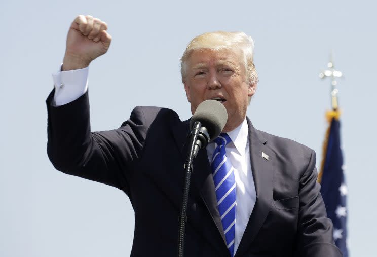 President Trump pumps his fist as he addresses the graduating class of the U.S. Coast Guard Academy during commencement ceremonies in New London, Conn., on May 17, 2017. (Photo: Kevin Lamarque/Reuters)