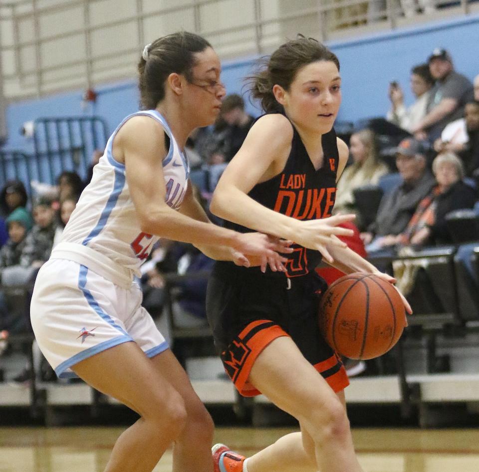 Marlington's Allie Gill, right, is defended by Alliance's Payton Smith, left, during action at Alliance High School Wednesday night, February 1, 2023.