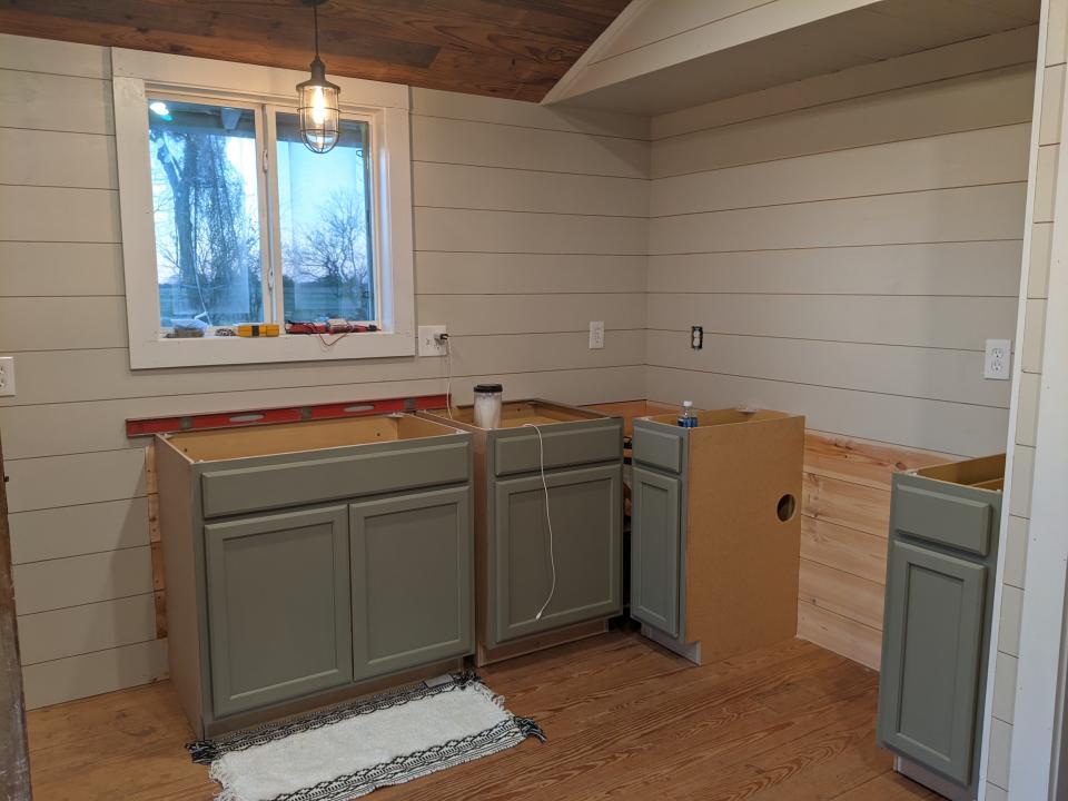 Cabinets are being installed in the kitchen.