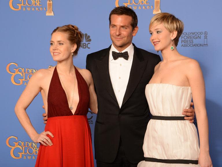 Actors Amy Adams, Bradley Cooper and Jennifer Lawrence, stars of "American Hustle", during the 71st Annual Golden Globe Awards in Beverly Hills, California, January 12, 2014