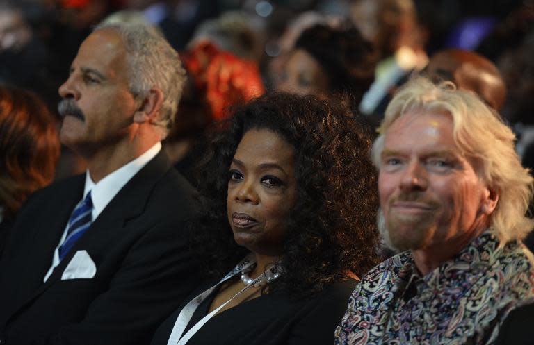 British entrepreneur Richard Branson (R) and US TV host Oprah Winfrey attend the funeral ceremony of South African former president Nelson Mandela in Qunu on December 15, 2013
