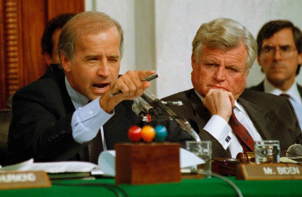 In this Oct. 12, 1991 file photo, then Senate Judiciary Committee Chairman Sen.  Joe Biden, D-Del., points angrily at Clarence Thomas during comments at the end of hearings on Thomas' nomination to the Supreme Court on Capitol Hill. Sen. Edward Kennedy, D-Mass. looks on at right.