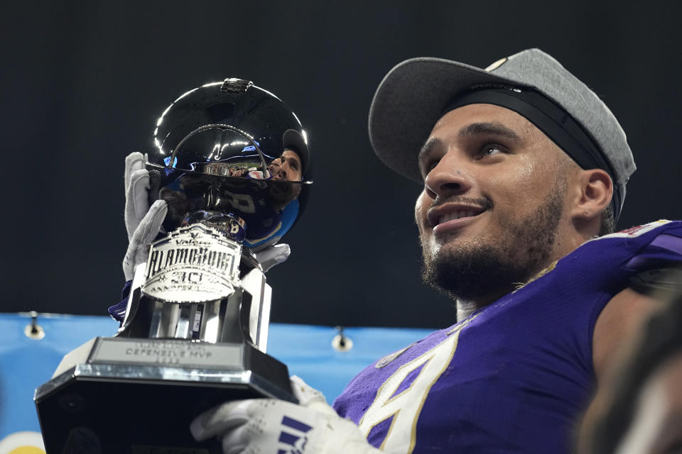 FILE - Washington defensive lineman Bralen Trice holds his Defensive MVP trophy after defeating Texas in the Alamo Bowl NCAA college football game in San Antonio, Thursday, Dec. 29, 2022. Washington opens their season at home against Boise State on Sept. 2. (AP Photo/Eric Gay, File)
