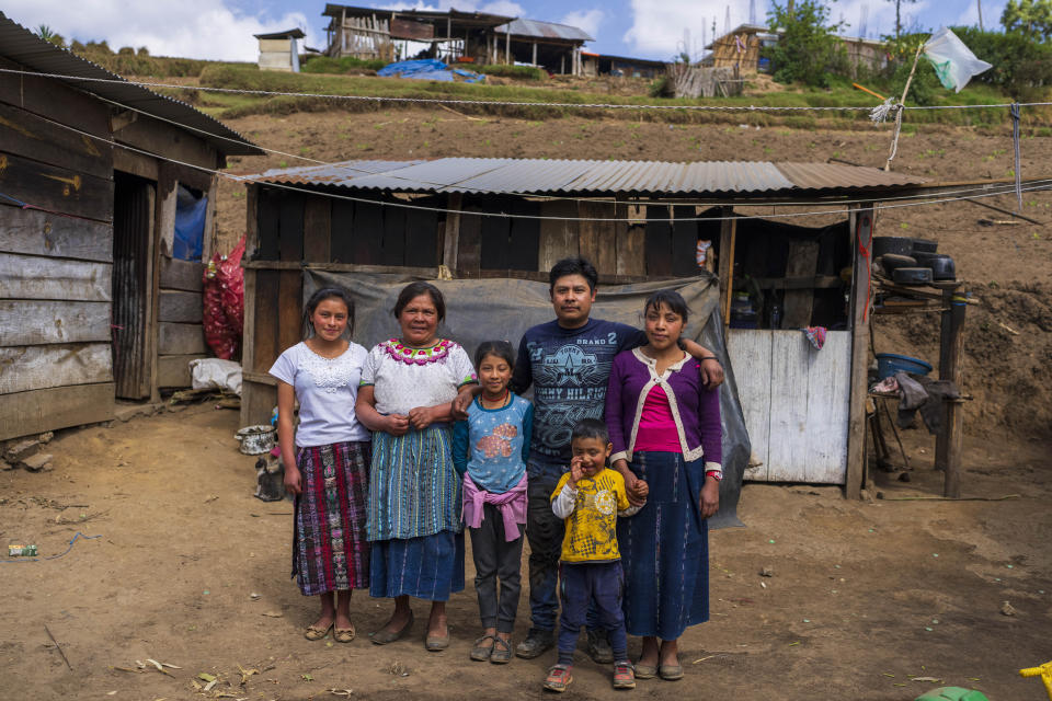 Reina Coronado, second from left, poses for a portrait with her family in Comitancillo, Guatemala, Tuesday, March 19, 2024. Coronado's 21-year-old daughter Aracely died alongside 50 other migrants, asphyxiated in a smuggler's trailer truck in San Antonio, Texas in June 2022, despite trying to convince her eight children that they didn’t have to risk their lives. From left are her children Adaly, Diana, Alexis, daughter-in-law Amelia and grandson Eduard. (AP Photo/Moises Castillo)
