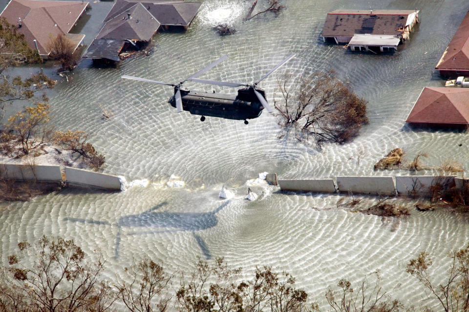 A Chinook helicopter on Sept. 11, 2005, flies in sandbags to plug a levee break from Hurricane Katrina in the Gentilly neighborhood of New Orleans.