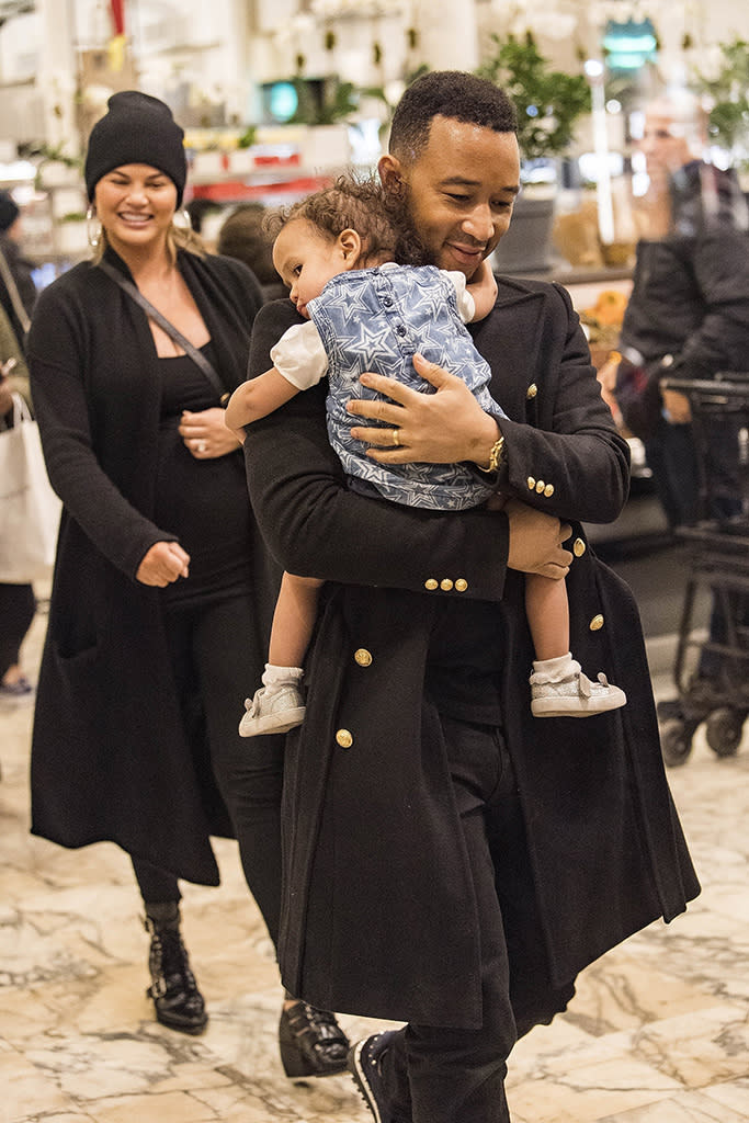 <p>The adorable family shopped for some goodies at the Dean & Deluca store in Manhattan’s Soho neighborhood on Monday. Chrissy, who’s expecting the couple’s second child, a boy, looked lovingly at her hubby who carried their daughter in his arms. (Photo: Backgrid) </p>