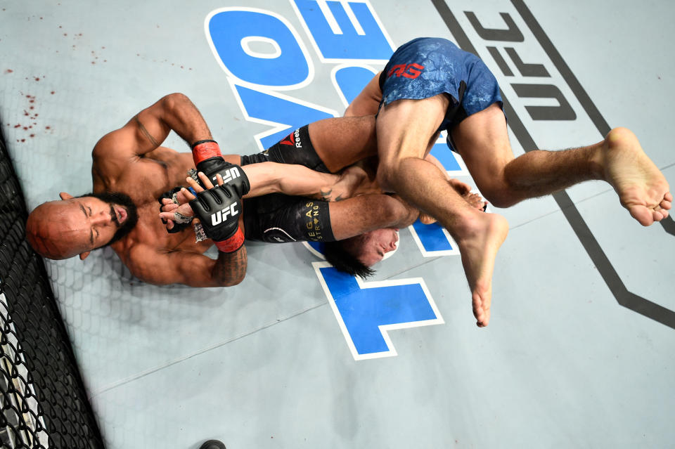 UFC flyweight champion Demetrious Johnson has the arm bar locked in before Ray Borg even hits the ground after being suplexed. (Getty)