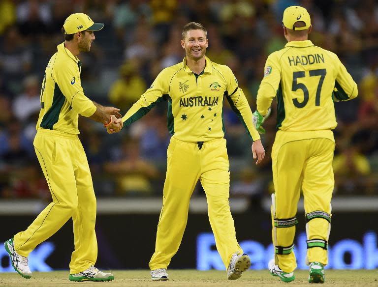 Australia's Michael Clarke (C) celebrates with teammates during the 2015 Cricket World Cup Pool A match between Australia and Afghanistan in Perth on March 4, 2015