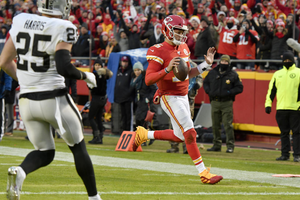 Kansas City Chiefs quarterback Patrick Mahomes (15) runs for a touchdown as Oakland Raiders safety Erik Harris (25) watches during the first half of an NFL football game in Kansas City, Mo., Sunday, Dec. 1, 2019. (AP Photo/Ed Zurga)