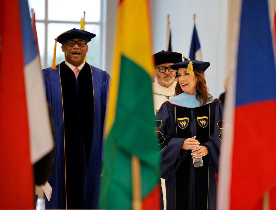 U.S. Rep. Marc Veasey of Fort Worth and Emily W. Messer walk past flags representing students’ home countries during Messer’s investiture as the 21st and first female president in Texas Wesleyan history.