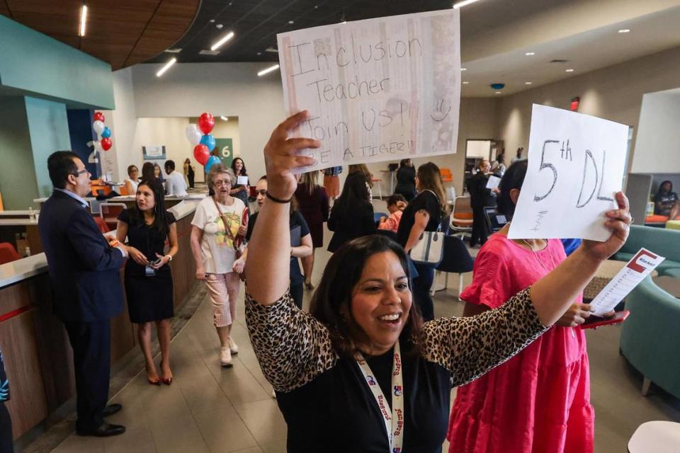 Rozanne Lopez of D. McRae Elementary School greets prospective teaching candidates at the entrance during a Fort Worth Independent School District-wide teacher hiring fair at the FWISD Teaching and Learning Center on Thursday, July 27, 2023.