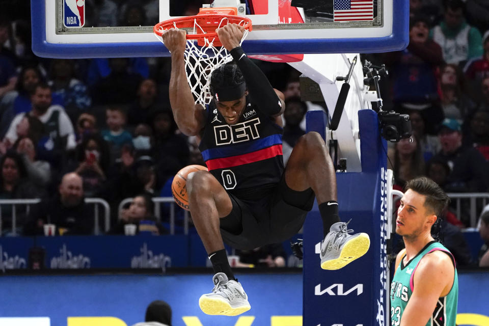 Detroit Pistons center Jalen Duren (0) dunks on San Antonio Spurs forward Zach Collins (23) in the second half of an NBA basketball game in Detroit, Friday, Feb. 10, 2023. (AP Photo/Paul Sancya)