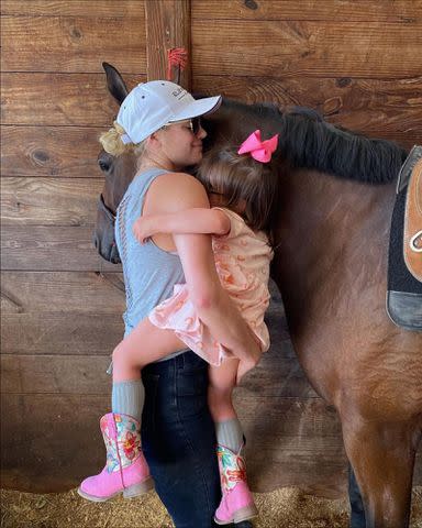 <p>Kate Upton Instagram</p> Kate Upton holds her daughter Genevieve Upton Verlander next to a horse in 2021.
