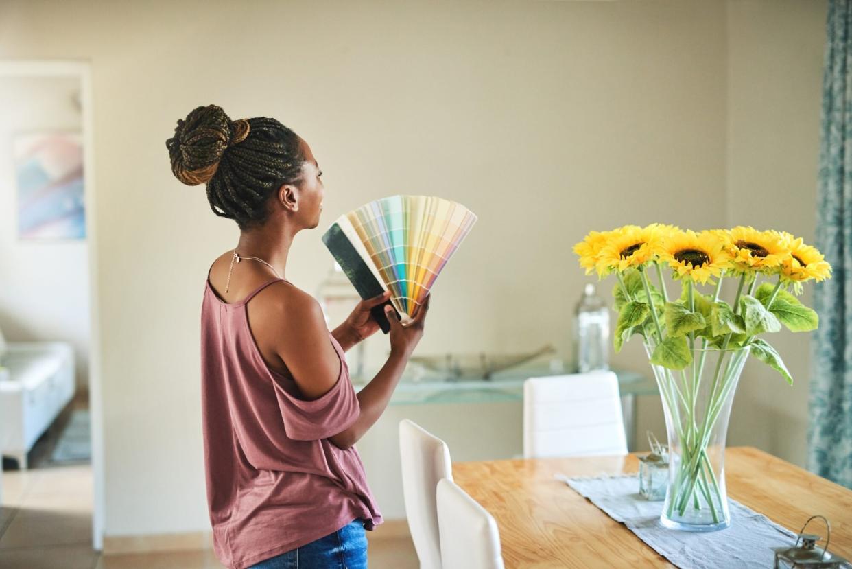 woman looking at paint colors for wall