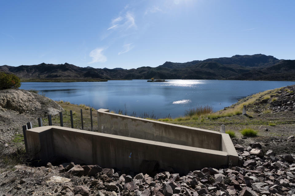 The water glistens in the sunlight at the Las Virgenes Municipal Water District's reservoir in Westlake Village, Calif., Wednesday, Jan. 5, 2022. The Las Virgenes Municipal Water District's approach is one example of how water districts are pushing Californians to save as the drought continues despite a wet start to winter. Las Virgenes is installing a new metering system that gives people a real-time look at their water use. It's also lowering the threshold for penalizing wasters and threatening to restrict the flow of water for households that don't get their water use back under control. (AP Photo/Jae C. Hong)