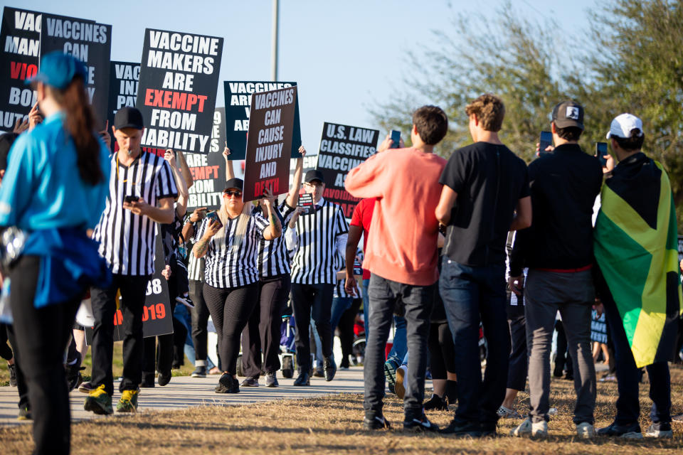 Feb 7, 2021; Tampa, Florida, USA; Maskless fans film anti-vaccination protesters outside of the Healthcare Heroes entrance to Raymond James Stadium before Super Bowl LV between the Kansas City Chiefs and the Tampa Bay Buccaneers. (Mary Holt/USA TODAY Sports via reuters)