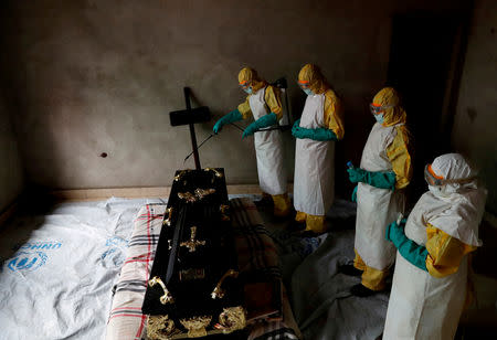 FILE PHOTO: A healthcare worker sprays a room during the funeral of Kavugho Cindi Dorcas, who is believed to have died of Ebola in Beni, North Kivu Province of Democratic Republic of Congo, December 9, 2018. REUTERS/Goran Tomasevic/File Photo