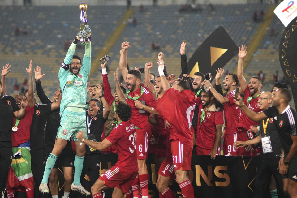 Al Ahly players celebrate with the trophy after winning the CAF Champions League final soccer match between Morocco's Wydad Athletic Club and Egypt's Al Ahly SC, at the Mohammed V stadium, in Casablanca, Morocco, Sunday, June 11, 2023. (AP Photo/Mosa'ab Elshamy)