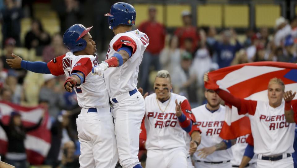 Puerto Rico's Carlos Correa celebrates a two-run home run with Francisco Lindor, left, against the Netherlands in the first inning of a semifinal in the World Baseball Classic in Los Angeles, Monday, March 20, 2017. (AP Photo/Chris Carlson)