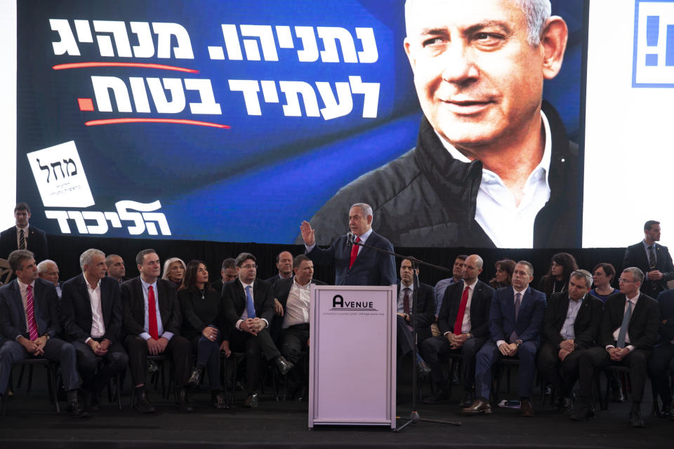 Israeli Prime Minister Benjamin Netanyahu, center, speaks during a Likud faction meeting in Tel Aviv, Israel, Sunday, March 1, 2020. (AP Photo/Sebastian Scheiner)