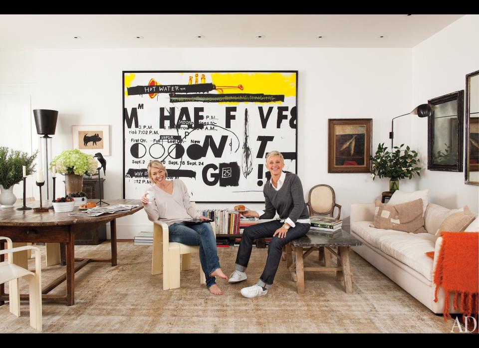 Portia and Ellen kick back in one of the sitting areas in their house where the couple hung a graphic piece of art made by Andy Warhol and Jean-Michel Basquiat.     To see more, head on over to <a href="http://www.architecturaldigest.com/homes/homes/2011/11/ellen-degeneres-and-portia-de-rossi-beverly-hills-home-article" target="_hplink">architecturaldigest.com</a>.