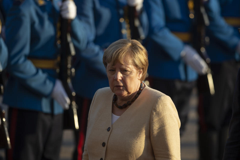 German Chancellor Angela Merkel walks past honor guards during her visit to Belgrade, Serbia, Monday, Sept. 13, 2021. Merkel is on a farewell tour of the Western Balkans, as she announced in 2018 that she wouldn't seek a fifth term as Germany's Chancellor. (AP Photo/Marko Drobnjakovic)