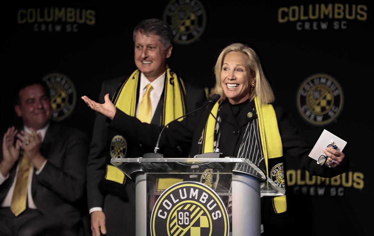 Dee Haslam, a member of the ownership group for Columbus Crew SC, turns to the crowd after receiving a club scarf from fellow owner-operator Pete Edwards, second from left, during an introductory press conference on Wednesday, January 9, 2019 at Two Miranova in Columbus, Ohio. New owner-operators Dee Haslam and Pete Edwards were formally introduced along with new Crew SC general manager Tim Bezbatchenko and new Crew SC manager Caleb Porter. [Joshua A. Bickel/Dispatch]