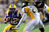 Jordan Dangerfield #20 and Telvion Clark #13 of the Towson Tigers pursue Michael Ford #42 of the LSU Tigers during a game at Tiger Stadium on September 29, 2012 in Baton Rouge, Louisiana. LSU would win the game 38-22. (Photo by Stacy Revere/Getty Images)