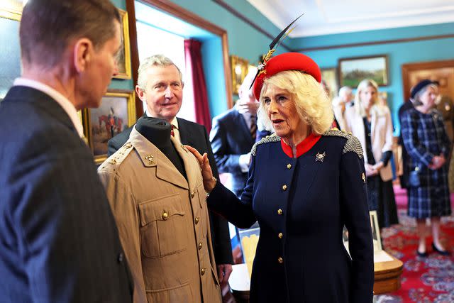 <p>Chris Jackson/WPA Pool/Getty</p> Queen Camilla views a tunic that belonged to her father, the late Major Bruce Shand, during her visit to The Royal Lancers on April 22, 2024.