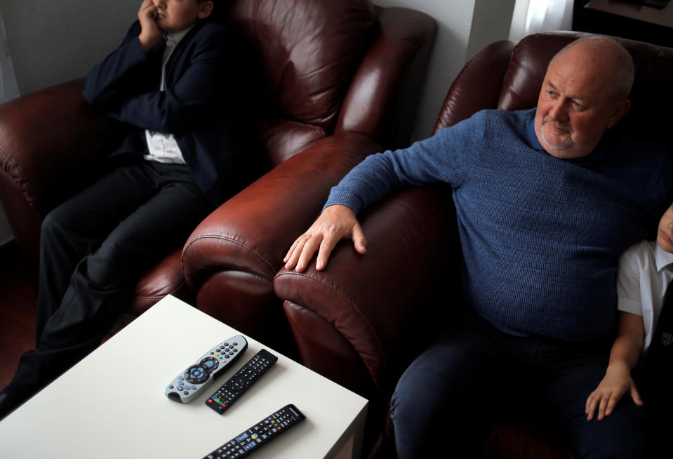 Alf Brewer, 66, a British retiree living in Spain, sits with his grandchildren as he watches on a TV screen a live debate of MPs at the Houses of Parliament in London, ahead of a vote on Prime Minister Theresa May's Brexit deal, at his home in Benalmadena, southern Spain January 15, 2019. REUTERS/Jon Nazca