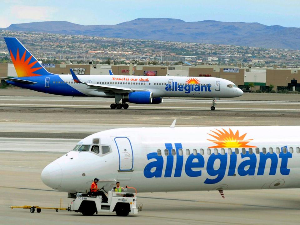 File - In this May 9, 2013, file photo, two Allegiant Air jets taxi at McCarran International Airport in Las Vegas. Federal safety regulators want to fine Allegiant Air more than $715,000, saying the discount airline failed to properly fix an engine that put out hotter-than-normal exhaust fumes. Allegiant says that it followed a procedure approved by the manufacturer and the government. (AP Photo/David Becker, File)