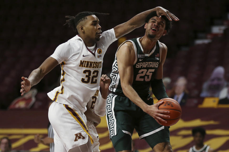 Michigan State's Malik Hall (25) is fouled by Minnesota's Sam Freeman (32) during the second half of an NCAA college basketball game, Monday, Dec. 28, 2020, in Minneapolis. Minnesota won 81-56. (AP Photo/Stacy Bengs)