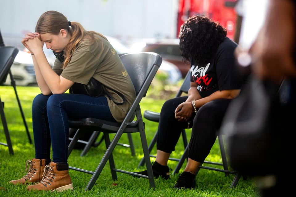 Naomi del Pilar bows her head in prayer at an event Friday, July 8, 2022 beside the Gadsden County Courthouse in Quincy, Fla. to grieve those affected by the recent fentanyl overdoses.