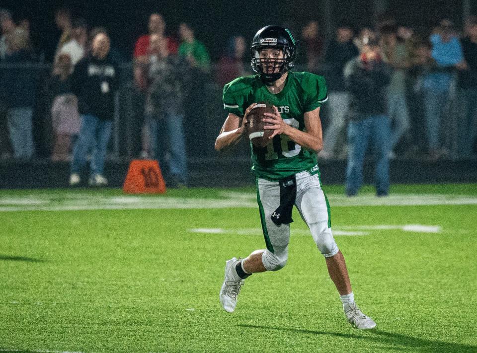 Clear Fork's Marcus Hoeflich looks for an open receiver during the Colts' 35-7 loss to Marion Harding on Friday night.