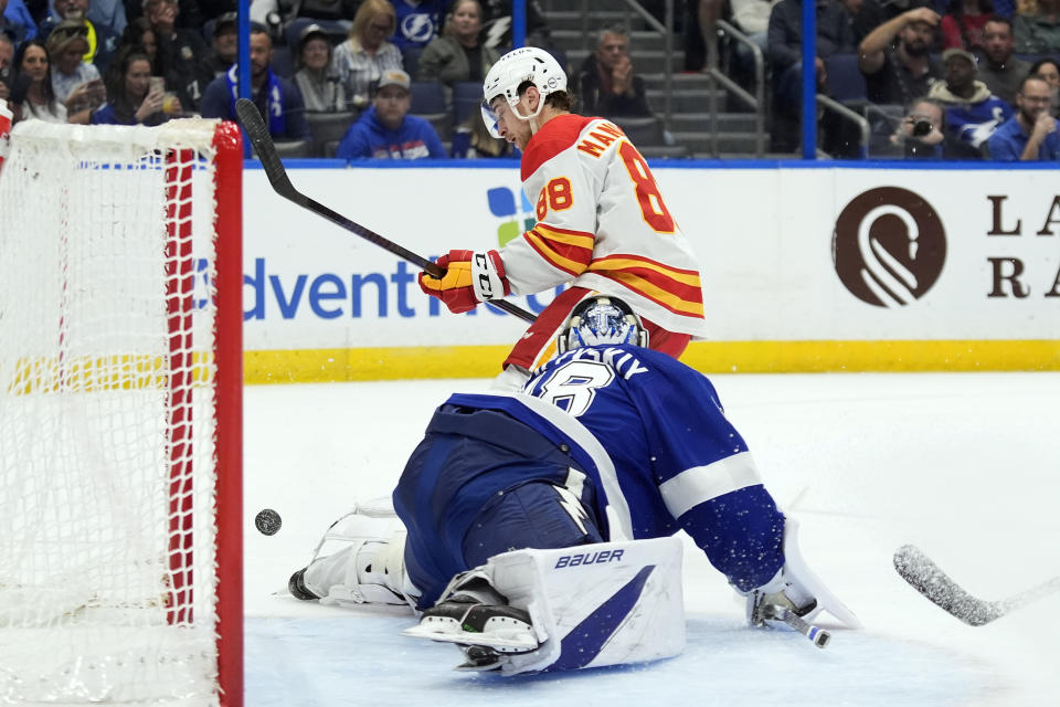Tampa Bay Lightning goaltender Andrei Vasilevskiy (88) stops a shot by Calgary Flames left wing Andrew Mangiapane (88) during the first period of an NHL hockey game Thursday, March 7, 2024, in Tampa, Fla. (AP Photo/Chris O'Meara)