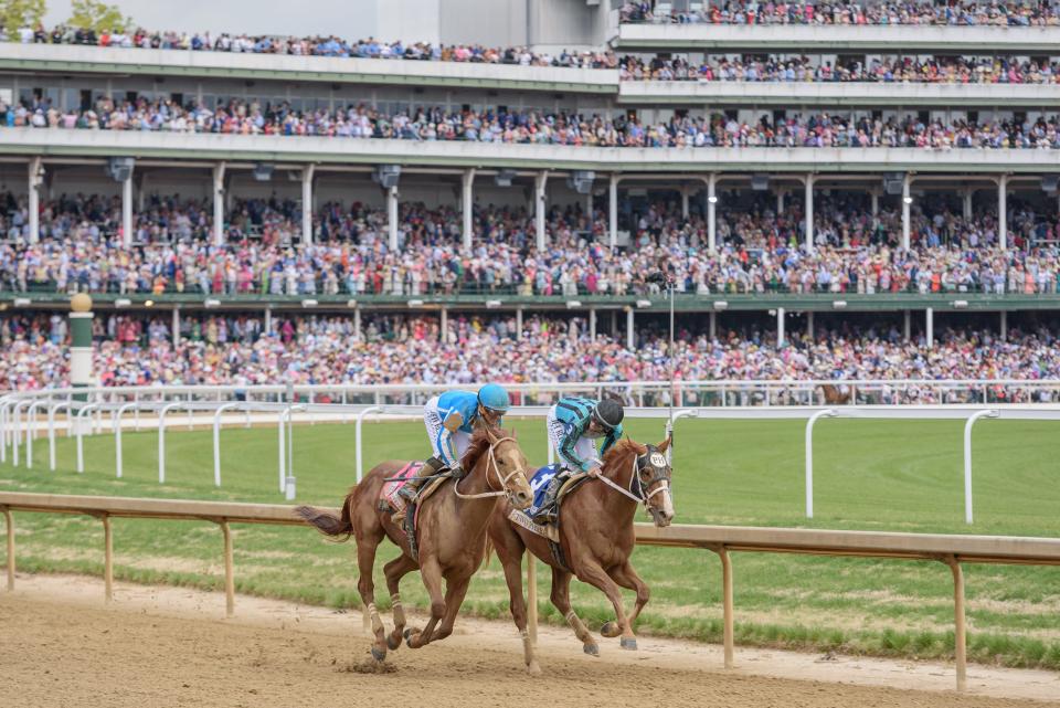Jockeys for the winner, Mage, and Two Phils talk as they run past the finish during the 149th running of the Kentucky Derby in Louisville, Ky. May 6, 2023