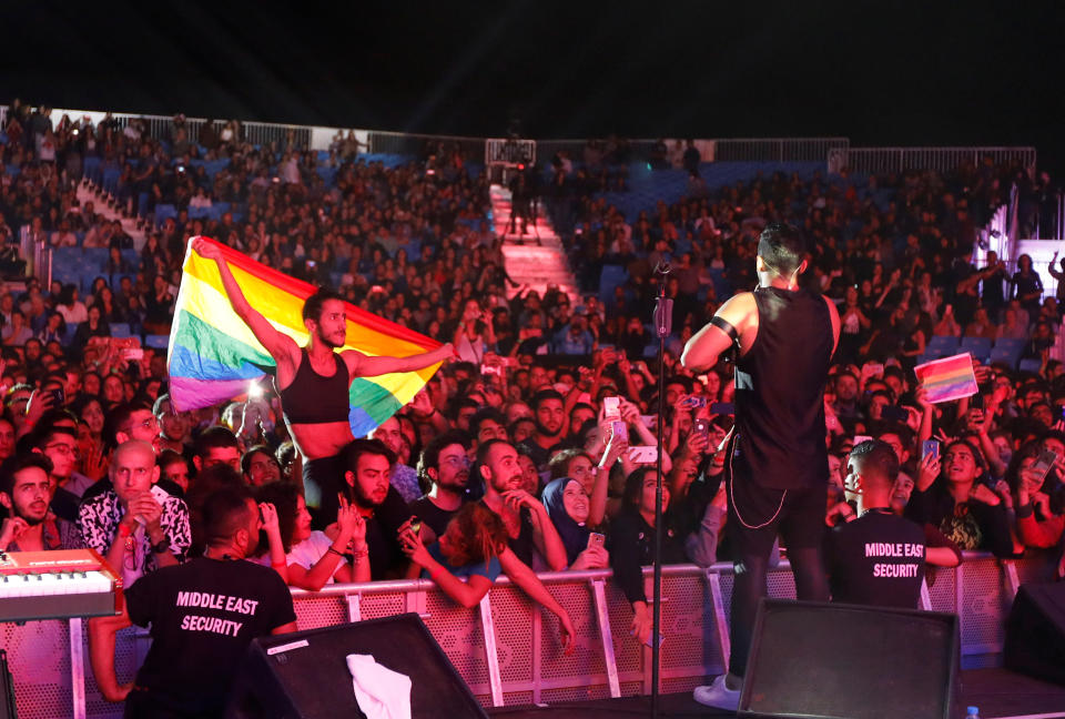 Image: A fan of Lebanese alternative rock band Mashrou' Leila holds a rainbow flag during their concert at the Ehdeniyat International Festival in Ehden town (Jamal Saidi / Reuters file)