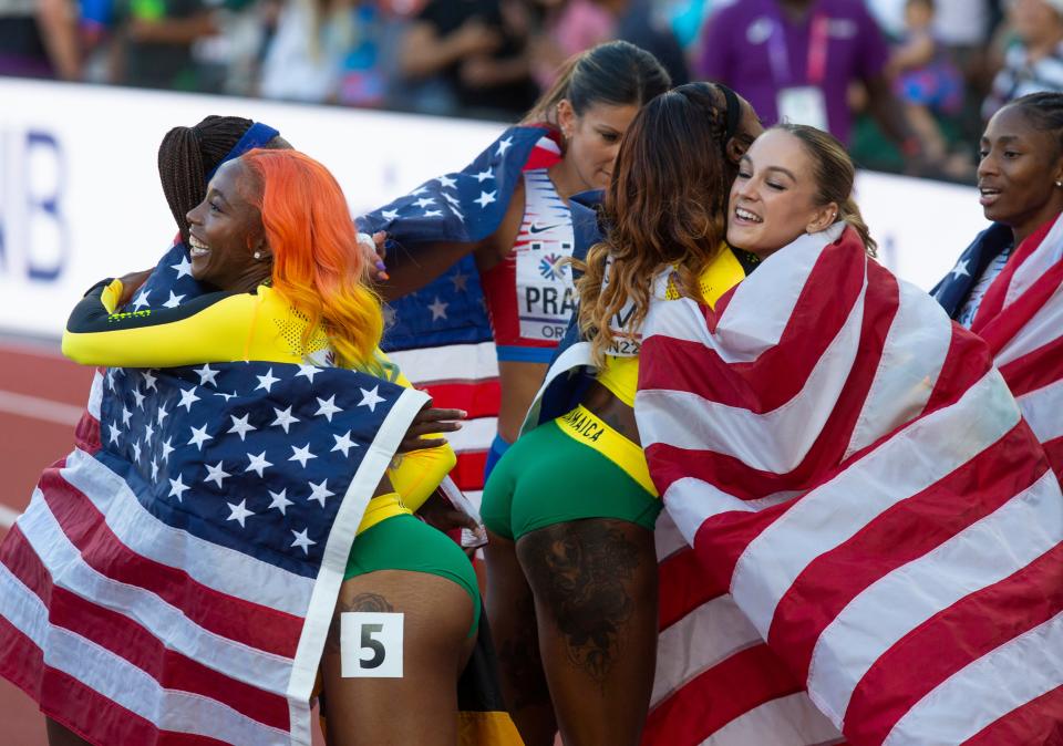 The silver medal Jamaican team congratulates the USA gold medal after the 4x100 relay at the World Athletics Championships at Hayward Field in Eugene, Oregon Saturday, July 23, 2022.